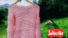 a pink sweater hanging on a clothes line with the words substile written below it