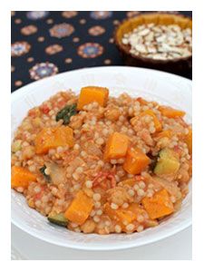 a white plate topped with food next to a bowl of oatmeal and vegetables