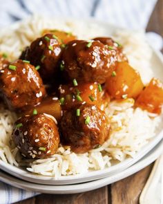 a white plate topped with meatballs and rice