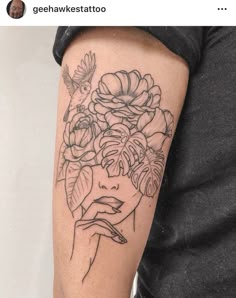 a woman's arm with flowers on it