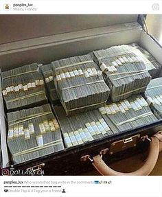 a suitcase filled with lots of money sitting on top of a table