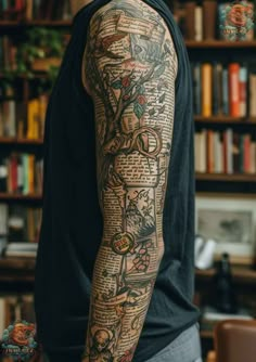 a man with tattoos on his arm and arms is standing in front of a bookshelf