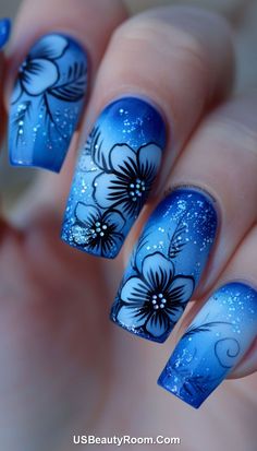 These nails showcase a gradient from deep blue to light blue, adorned with bold floral designs and sparkling accents. The striking combination of colors and intricate flowers creates a unique and artistic manicure, perfect for any stylish event. Blue Ombre Nail Designs, Blue Ombre Nail, Neon Nail Art, Blue Ombre Nails, Kawaii Nail Art, January Nails, Ombre Nail, Ombre Nail Designs, Blue Nail Designs