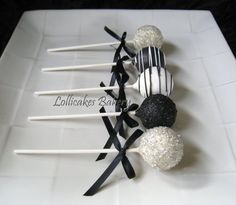 cake pops with black and white toppings on a plate