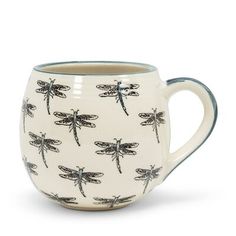 a coffee cup with dragonflies on it