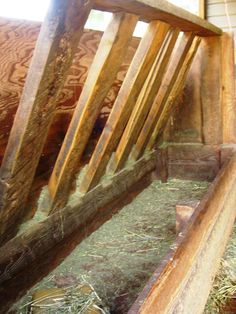 the inside of an animal pen with hay in it