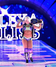 a female wrestler is walking down the runway