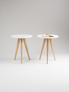 two white tables sitting side by side on top of each other