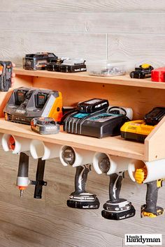 there are many different tools hanging on the wall above the shelf and below it is an electric driller