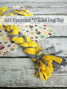 a yellow and gray dog toy on top of a wooden table