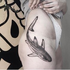 a woman with a tattoo on her thigh