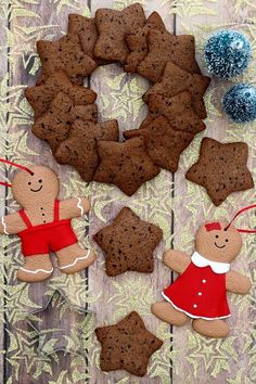 gingerbread cookies arranged in the shape of stars and wreaths on a wooden table