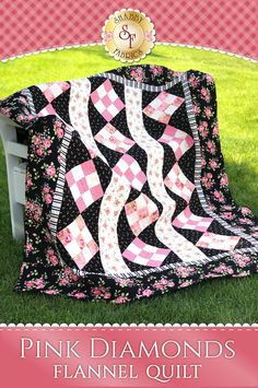 a pink and black quilt sitting on top of a chair in the grass with text overlay