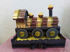 a cake made to look like a train with chocolates on the front and sides