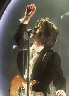 a man in a suit singing into a microphone