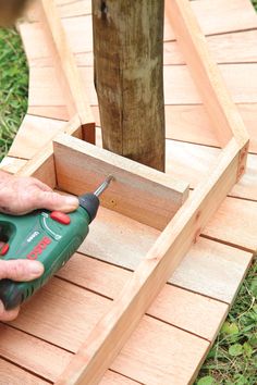 a person is using a drill to fix a piece of wood