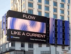 a large sign on the side of a building that says flow like a current source