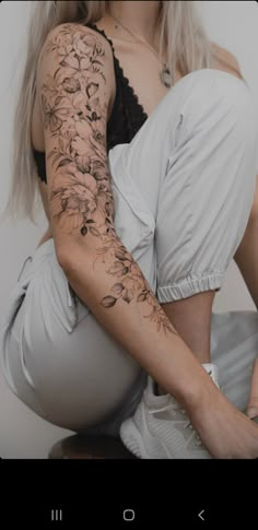 a woman with tattoos on her arm and leg