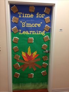 a door decorated to look like a campfire with the words time for s'more learning on it