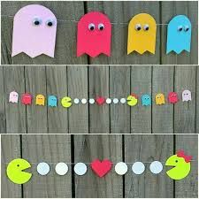 paper pacman garlands are hanging on a fence