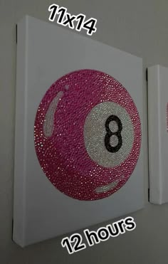 two pink and white balls with numbers painted on them are shown in the same size