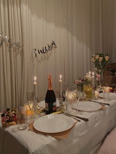 the table is set with champagne and candles