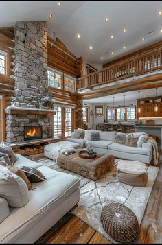 a living room filled with lots of furniture and a fire place in the middle of it