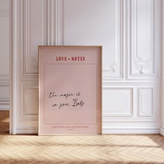 a pink poster with the words love notes on it in front of a white wall