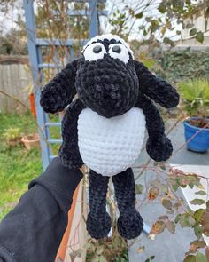 a black and white stuffed animal hanging from a tree