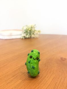 a green toy sitting on top of a wooden table