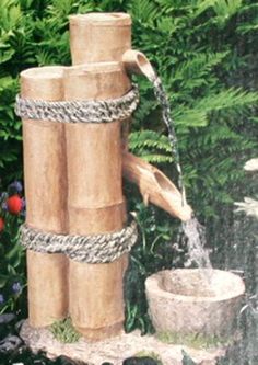 a water fountain made out of wood and rope