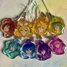 six cartoon keychains with different designs on them