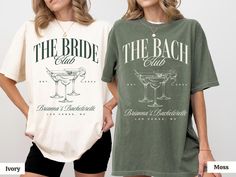 two women standing next to each other wearing t - shirts with the words, the bride and groom on them