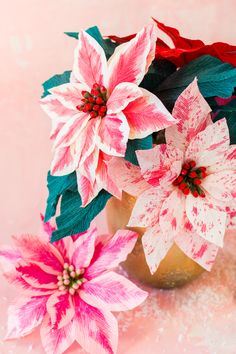 some pink and white flowers are in a vase