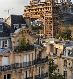 the eiffel tower towering over paris is seen in this view from an apartment building