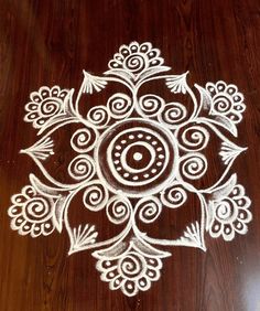 a wooden table with white painted designs on it