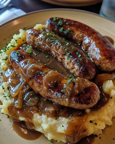 two sausages and mashed potatoes on a plate