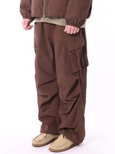 Editor's NotesTHAT`S IT's parachute pants has a trendy and casual look with diagonal cargo pocket detail, deep tuck, and string and stopper on the hem. You can style it with various items during multiple seasons. - Diagonal cargo pocket detail- Natural wrinkle on the fabric- Deep tuck for wide silhouette- String and stopper on the hemMeasurements (in.)M/L/XL- Length: 41.34 in. / 41.73 in. / 42.13 in.- Waist: 12.60 in. / 12.99 in. / 13.78 in.- Rise: 15.75 in. / 16.14 in. / 16.14 in.- Hip: 21.65 in. / 22.44 in. / 23.23 in.- Thigh: 14.17 in. / 14.57 in. / 14.96 in.- Hem: 9.84 in. / 10.24 in. / 11.02 in.* Model info: Height 6'1, Weight 143 lbs, Wearing size XLComposition & Care- Nylon 100%- Refer to care labelDesigner- by THAT`S IT Brown Baggy Parachute Pants For Fall, Brown Utility Pants For Outdoor Activities, Brown Cargo Pants With Multiple Pockets For Outdoor Activities, Brown Cargo Pants With Side Pockets For Outdoor, Brown Baggy Utility Pants, Brown Baggy Cargo Pants For Fall, Baggy Brown Utility Pants, Utility Style Brown Bottoms For Outdoor Activities, Brown Utility Bottoms For Outdoor Activities