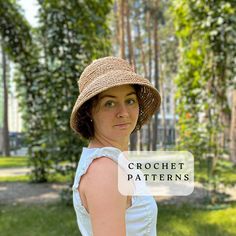 a woman wearing a straw hat in the park