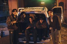 group of young men standing in the back of a car