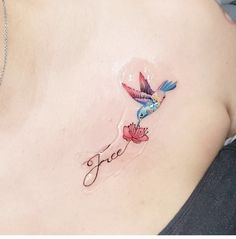 a woman with a tattoo on her stomach has a hummingbird flying over the word free