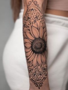 a woman with a sunflower tattoo on her arm