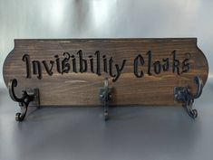 a wooden sign that says, invisibity cloaks on it's side