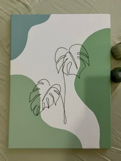 a drawing of two palm trees on top of a sheet of paper next to scissors