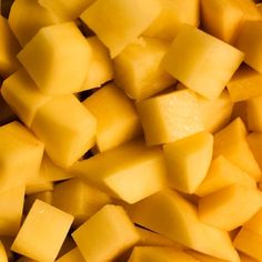 cubes of diced yellow fruit sitting on top of each other in a pile