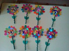 several colorful flowers are arranged on a white board