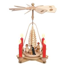 a christmas tree with candles and an angel figurine