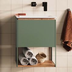 a green cabinet with towels on it in a bathroom