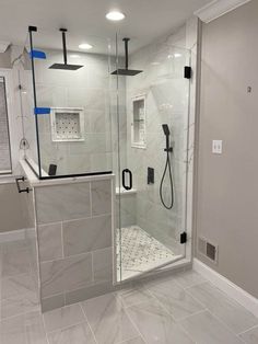 a walk in shower sitting inside of a bathroom