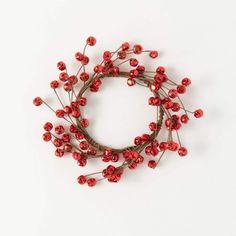 red berries are arranged in a circle on a white surface